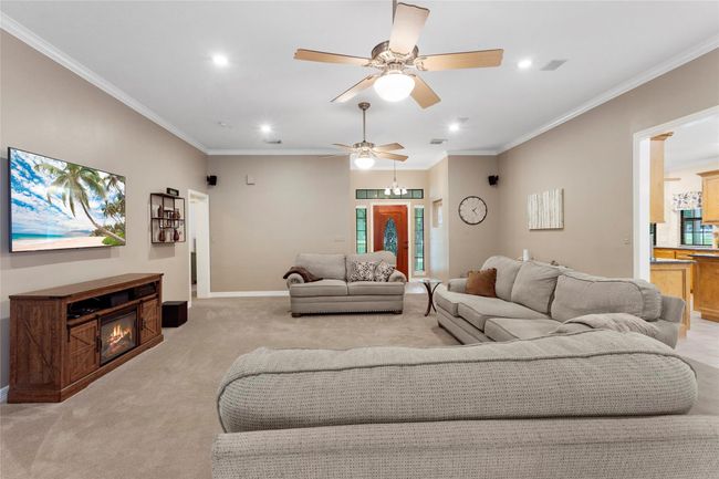 Split floorplan with 2 bedrooms off the front hallway and primary bedroom in back. | Image 12