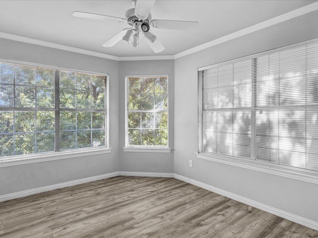 2nd floor bedroom with plenty of natural light, built in cabinets, ceiling fan & laminated floors | Image 26