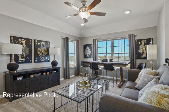 Carpeted living area featuring baseboards and ceiling fan | Image 12