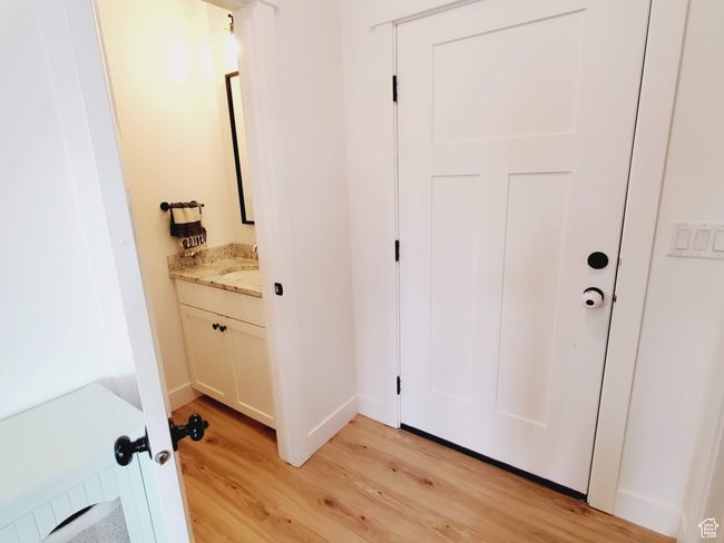 Doorway to outside featuring baseboards and light wood-style floors | Image 8