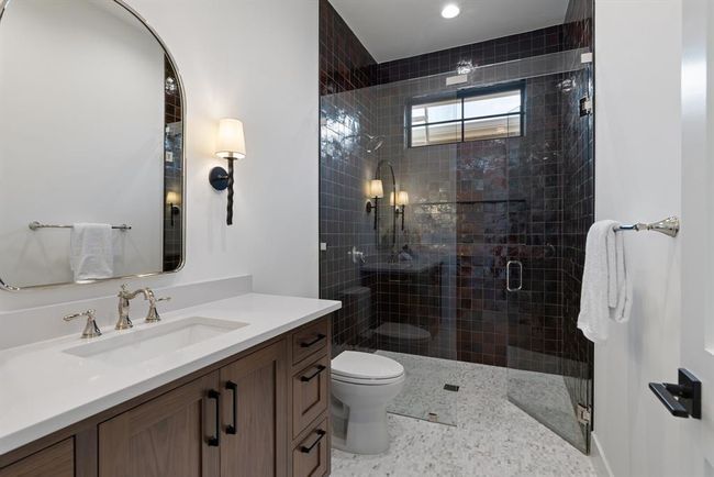 Bathroom with vanity, toilet, and a shower stall | Image 5