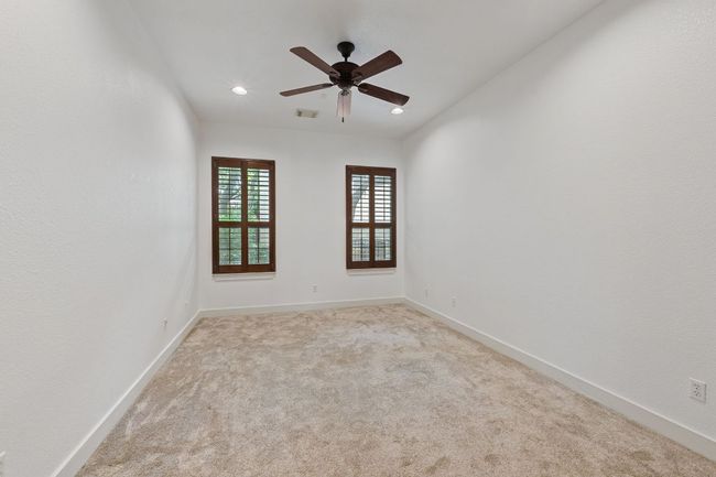 Carpeted empty room featuring ceiling fan and recessed lighting | Image 8