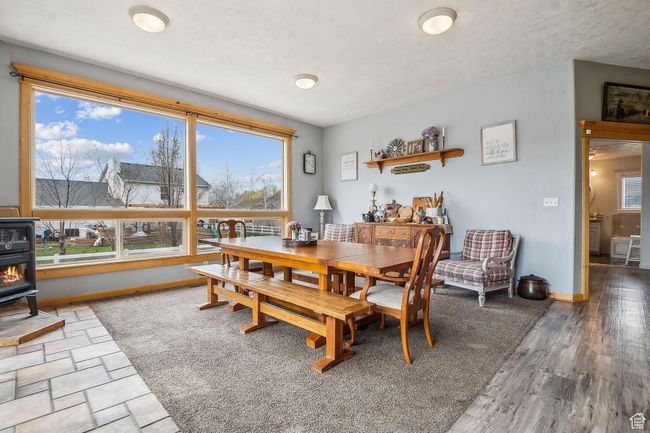 Dining room with baseboards and a wood stove | Image 18