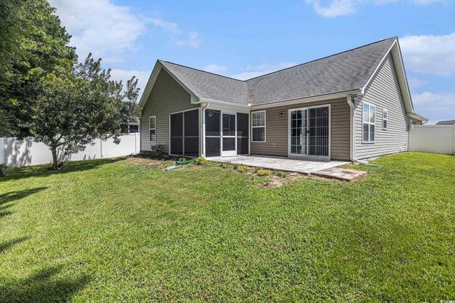 Back of house featuring a patio, a fenced backyard, roof with shingles, and a sunroom | Image 34