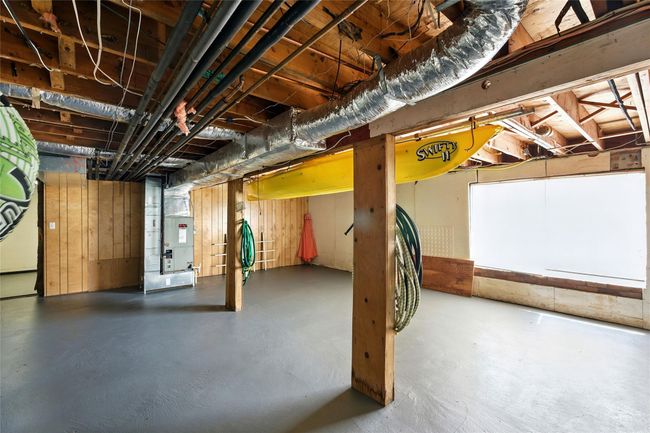 Unfinished basement featuring heating unit | Image 39