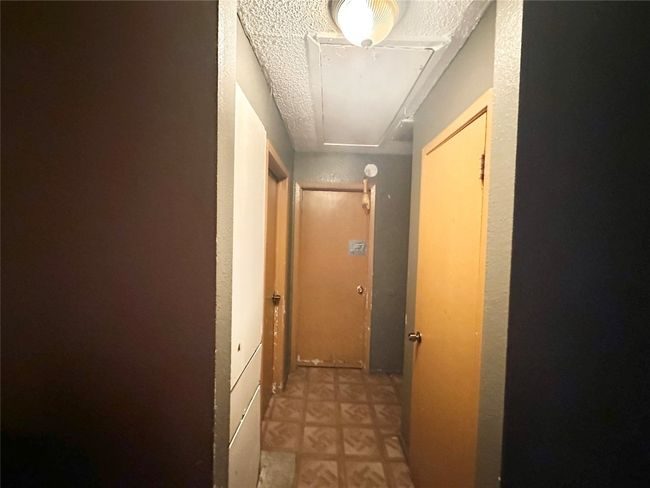 Hallway with attic access and a textured ceiling | Image 25