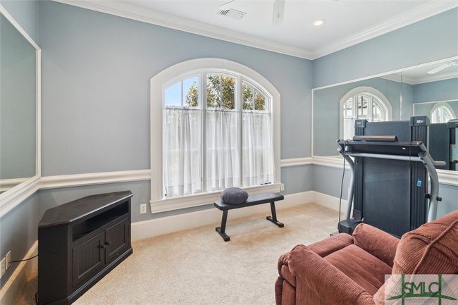 Also part of the primary suite is a room currently serving as a fitness room. It has a second door to the hallway and can be used as a nursery, a sitting area, a crafts room or a multitude of other uses. | Image 30