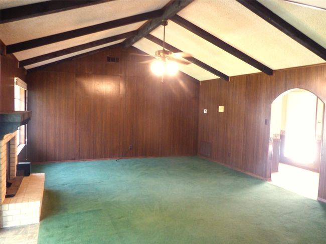 Spacious and sunlit living area with large windows and a cozy layout—perfect for relaxing or entertaining. | Image 4