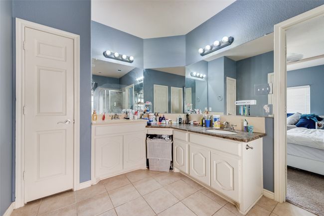 Full bathroom with tile patterned floors, ensuite bathroom, a stall shower, and double vanity | Image 16
