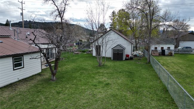 View of yard featuring an outdoor structure, a storage shed, and fence | Image 41
