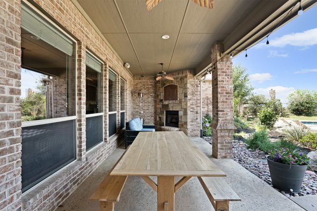 View of patio / terrace with a fireplace and ceiling fan | Image 36