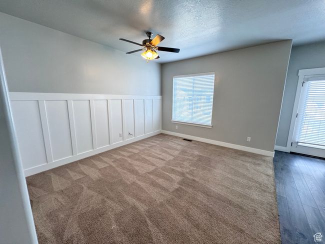 Spare room with visible vents, a wealth of natural light, a textured ceiling, and ceiling fan | Image 6
