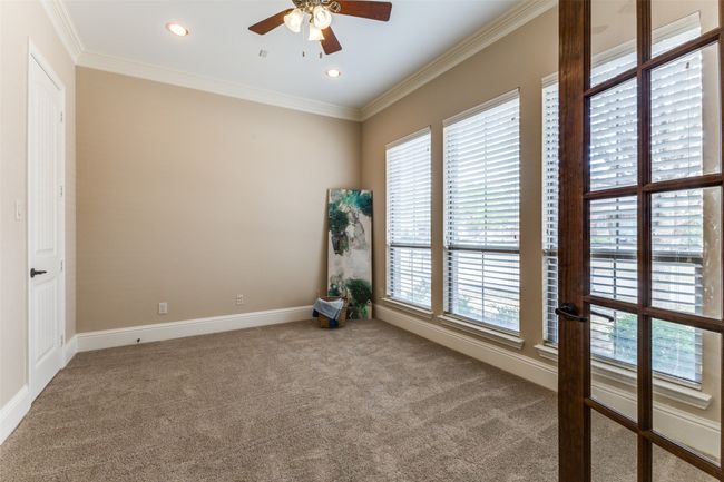 The downstairs bedroom, located to the right of the front door, offers an attached full bath, and could make a second office. There is an additional office downstairs. | Image 17