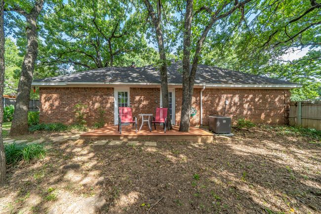 Back of house with a wooden deck and brick siding | Image 23
