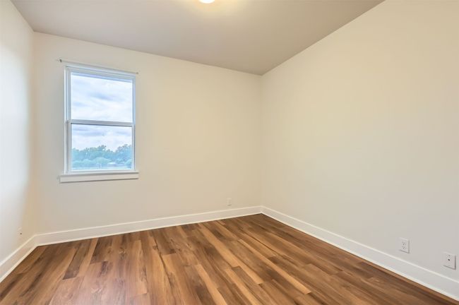 Unfurnished room featuring baseboards and dark wood-style flooring | Image 19