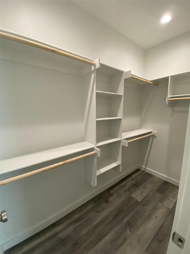 Spacious closet featuring dark wood-type flooring | Image 10