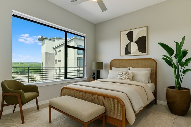 One of two secondary bedrooms features a large window with a black-out roller shade, and is cable wired for a wall-mount TV. | Image 12