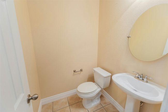 Bathroom with tile patterned flooring and toilet | Image 12