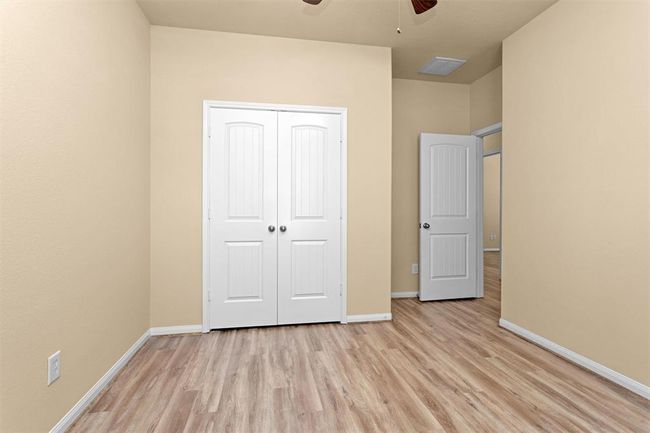 A spacious double-door closet provides ample storage, making this room ideal for children, guests, or a functional home office. | Image 21