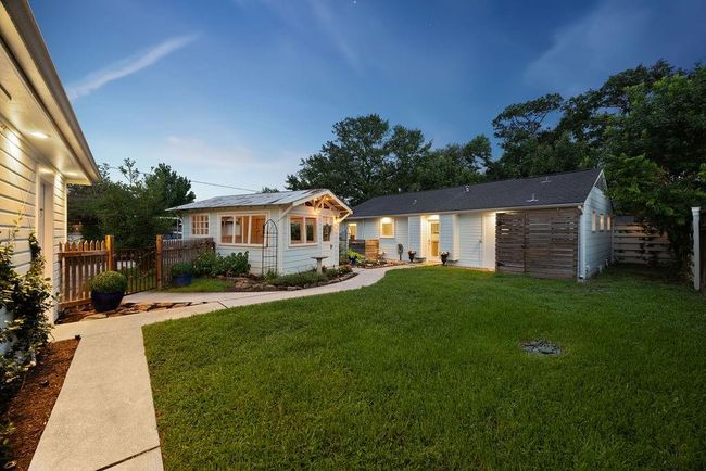 View of the backyard, looking toward the home. Notice the exterior lighting, which comes on automatically at dusk. | Image 23