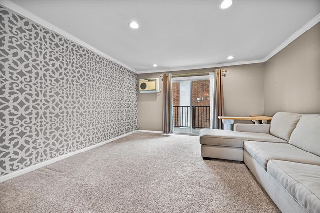Living area featuring a wall unit AC, recessed lighting, ornamental molding, carpet, and wallpapered walls | Image 7