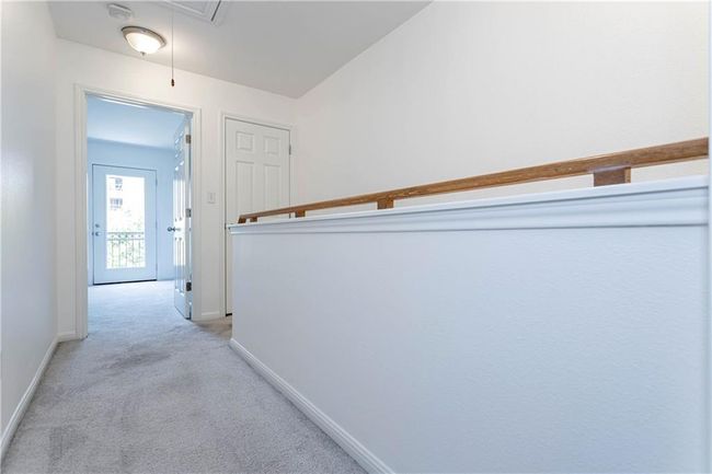 Corridor with light colored carpet and attic access | Image 13