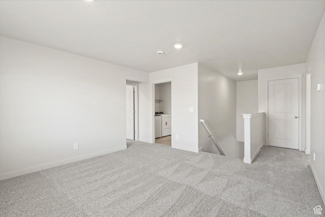 Empty room with separate washer and dryer, light colored carpet, and recessed lighting | Image 26