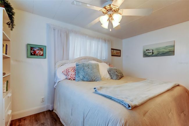 41. Bedroom #2 (11.6' x 13.2') Offers Standard Closet w Mirrored Sliders, Ceiling Fan, Gorgeous Furnishings..Sheer Curtains, Vertical Blinds. | Image 40