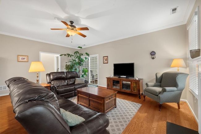 Spend time relaxing in this open family room. A slider door leads to the back patio. | Image 7