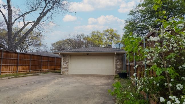 Garage featuring fence and concrete driveway | Image 10