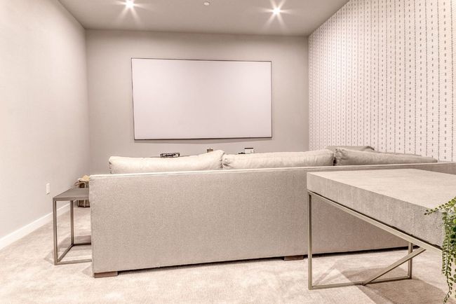 Cinema room with baseboards and light carpet | Image 30