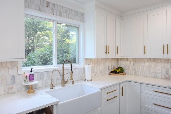 Kitchen featuring white cabinetry, healthy amount of natural light, and decorative backsplash | Image 6