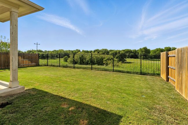 View of fenced backyard | Image 25