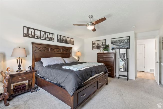 Bedroom featuring light colored carpet and a ceiling fan | Image 16