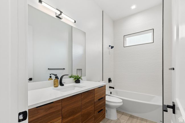 Full bathroom featuring toilet, shower / tub combination, and vanity | Image 22