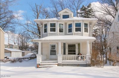 Victorian-style house featuring a garage and a porch | Image 1