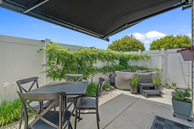 Fenced backyard featuring a patio and outdoor dining space | Image 31