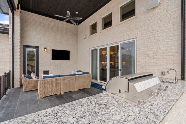 View of patio featuring a ceiling fan, an outdoor living space, and area for grilling | Image 36