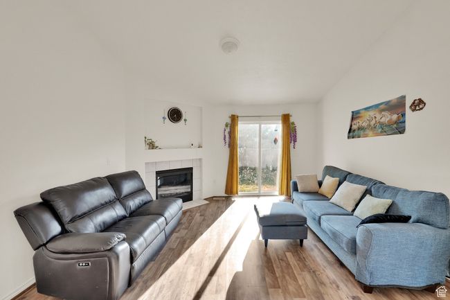 Living area featuring wood finished floors and a fireplace | Image 9