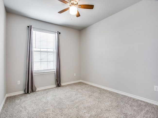 Empty room featuring ceiling fan, carpet flooring, and baseboards | Image 11