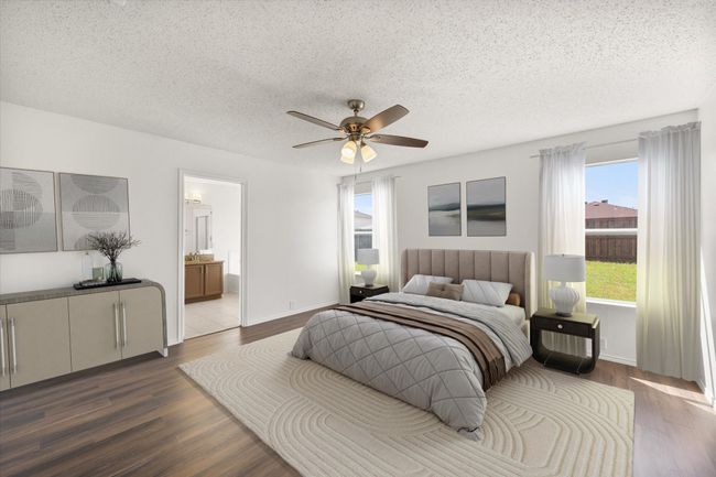 Computer staged Main Bedroom with dark wood-style floors, a textured ceiling, a ceiling fan, ensuite bath, and baseboards | Image 16