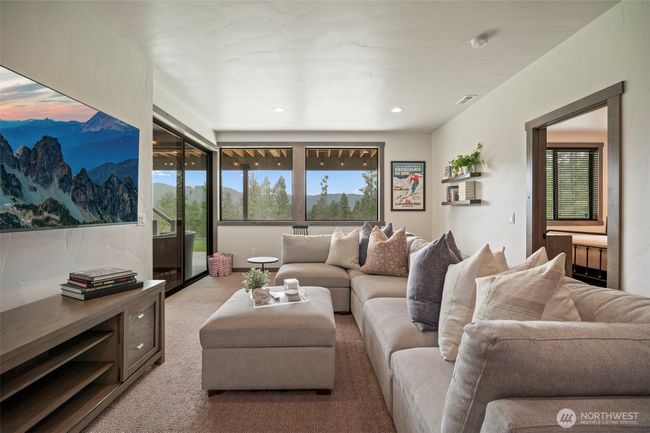 Head downstairs and you find another gathering area that leads out to a covered patio and a few steps from the hot tub - anyone want a soak? | Image 21