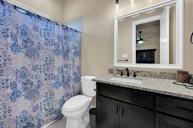 Bathroom featuring vanity, tile patterned flooring, a shower with shower curtain, and ceiling fan | Image 25