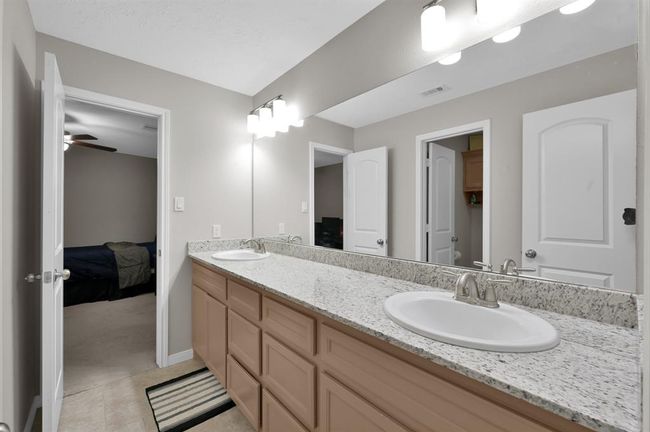 Double sinks & granite countertops with plenty of storage throughout. | Image 28