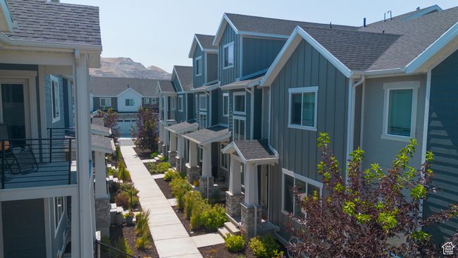 View of home's exterior with board and batten siding, roof with shingles, and a residential view | Image 4
