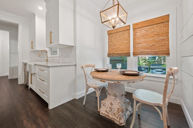 Dining room featuring dark wood finished floors, a chandelier, ornamental molding, and recessed lighting | Image 12