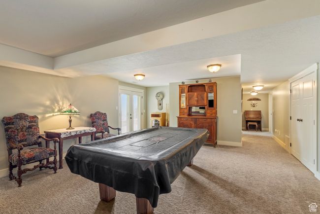Rec room with light carpet, pool table, french doors, and baseboards | Image 26