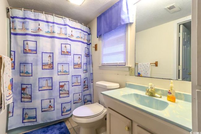 Bathroom featuring vanity, a textured ceiling, and a shower with curtain | Image 11