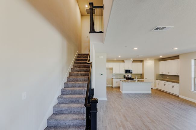 Staircase with wood finished floors and recessed lighting | Image 5