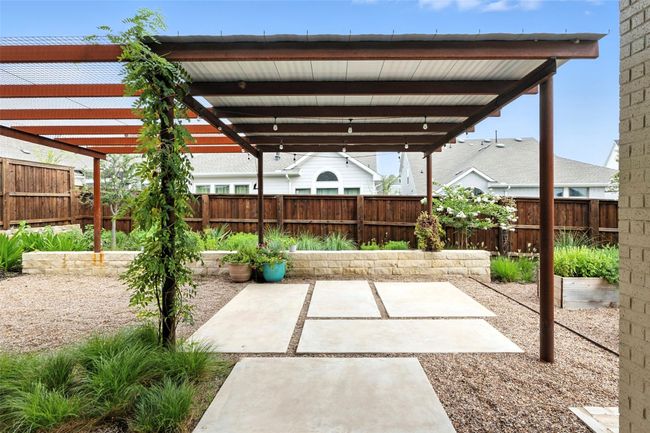 Fenced backyard with a patio | Image 30